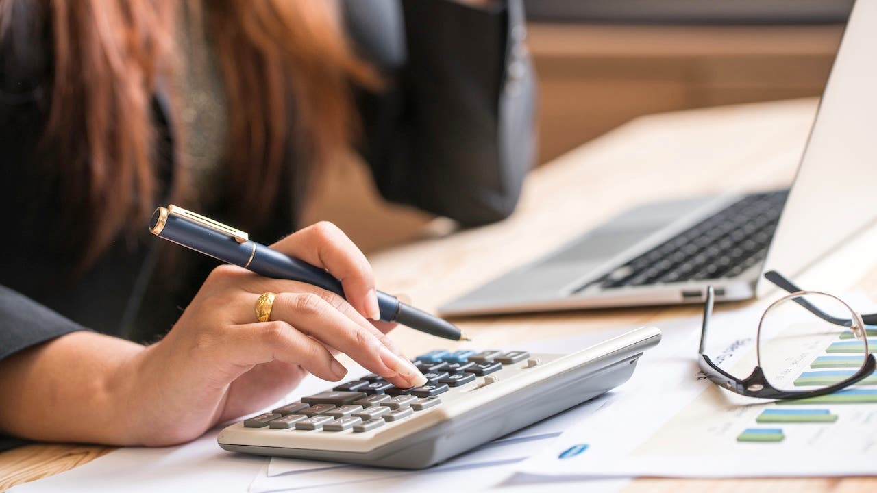 Close up of woman using a calculator