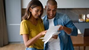 Two happy people looking at sheets of paper