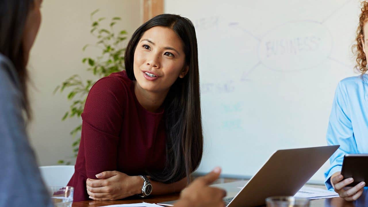 Business women discussing project at table in modern office