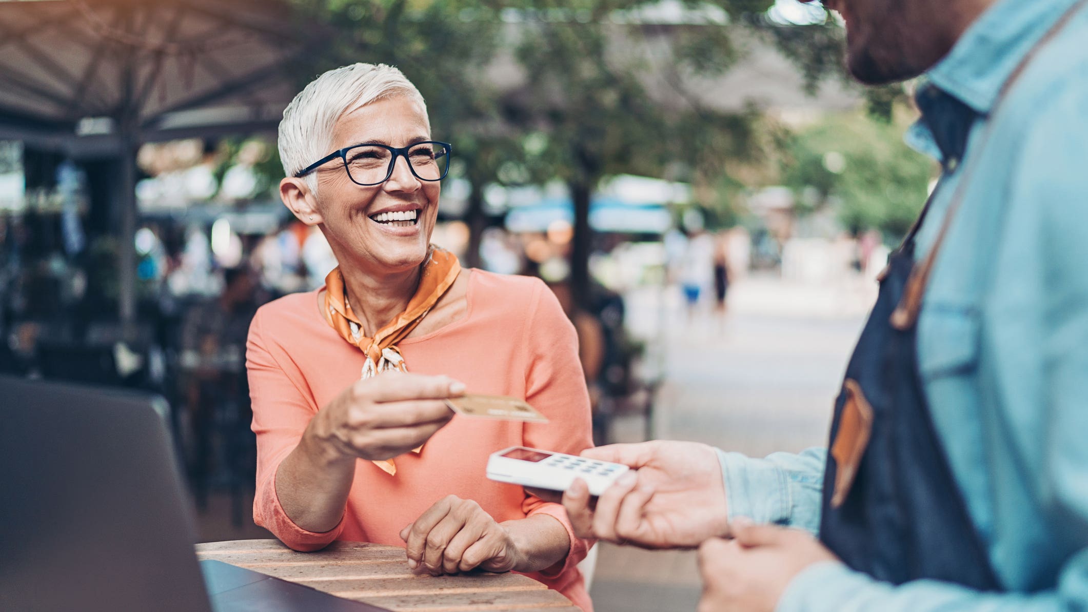 Smiling senior woman making a contactless payment