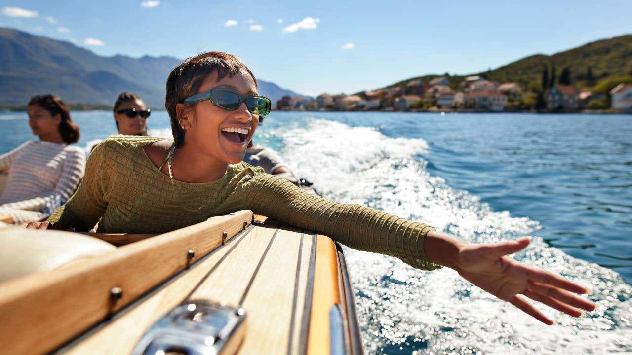 A cheerful woman on a speed boat.